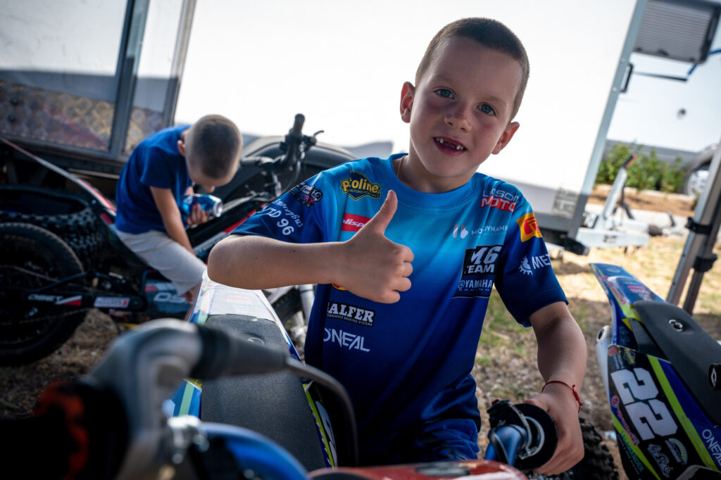 Radi gives a thumbs-up in the paddock